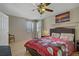Bright bedroom with light wood floors, ceiling fan, and an upholstered headboard on bed at 9552 Wooden Pier Way, Las Vegas, NV 89117