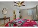 Bright bedroom with light wood floors, ceiling fan, and view into adjoining room at 9552 Wooden Pier Way, Las Vegas, NV 89117