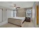 Bright bedroom with neutral walls and carpet, ceiling fan, and upholstered headboard on bed at 9552 Wooden Pier Way, Las Vegas, NV 89117