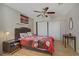 Comfortable bedroom with ceiling fan, wood flooring, a queen bed, and ample natural light at 9552 Wooden Pier Way, Las Vegas, NV 89117