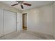 Bedroom with neutral walls and carpet, ceiling fan, closet and open door to hall at 9552 Wooden Pier Way, Las Vegas, NV 89117