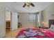 Bright bedroom with light wood floors, ceiling fan, and doorway to adjoining room at 9552 Wooden Pier Way, Las Vegas, NV 89117