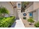 Inviting front entrance with a walkway lined by manicured bushes and a glimpse of the home's unique facade at 9552 Wooden Pier Way, Las Vegas, NV 89117