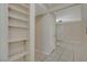 A hallway showing built-in shelves, a doorway, and the tile flooring at 9552 Wooden Pier Way, Las Vegas, NV 89117