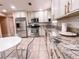 Kitchen with white cabinets, stainless appliances, granite countertops and tiled flooring at 9552 Wooden Pier Way, Las Vegas, NV 89117