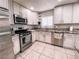 Updated eat-in kitchen features stainless appliances, granite countertops and white cabinets at 9552 Wooden Pier Way, Las Vegas, NV 89117