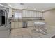 Eat-in kitchen featuring white cabinets, stainless steel appliances and tiled backsplash at 9552 Wooden Pier Way, Las Vegas, NV 89117
