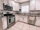 Modern kitchen boasts stainless steel appliances, granite countertops, and ample cabinet space at 9552 Wooden Pier Way, Las Vegas, NV 89117