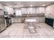 Bright eat-in kitchen boasts white cabinets, granite counters, stainless appliances, and decorative tile backsplash at 9552 Wooden Pier Way, Las Vegas, NV 89117