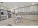 Bright eat-in kitchen featuring stainless steel appliances and sleek white cabinets at 9552 Wooden Pier Way, Las Vegas, NV 89117