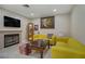 Comfortable living room featuring a fireplace, yellow sofas, and tasteful decor at 9552 Wooden Pier Way, Las Vegas, NV 89117