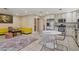 Open concept living room with kitchen island, tile flooring, and modern decor at 9552 Wooden Pier Way, Las Vegas, NV 89117