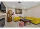 Comfortable living room featuring a fireplace, yellow sofas, and tasteful decor at 9552 Wooden Pier Way, Las Vegas, NV 89117