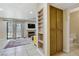 Open concept living room with fireplace, shelving and access to powder room at 9552 Wooden Pier Way, Las Vegas, NV 89117