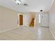 Open-concept living room with tile floors, access to stairs, and a built in storage unit at 9552 Wooden Pier Way, Las Vegas, NV 89117