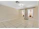 Bright living room with tile floors, natural light from bay window, and neutral walls perfect for personal touches at 9552 Wooden Pier Way, Las Vegas, NV 89117