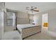 Bedroom with carpet, ceiling fan, windows, double closet, king bed, and ensuite bathroom at 9552 Wooden Pier Way, Las Vegas, NV 89117