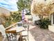 Charming patio with brick pavers features outdoor furniture, mature landscaping, and a peaceful seating arrangement at 9552 Wooden Pier Way, Las Vegas, NV 89117
