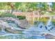 Community pond featuring a rock waterfall and lush landscaping at 9552 Wooden Pier Way, Las Vegas, NV 89117
