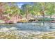 Community pond featuring a water aerator and rock shoreline at 9552 Wooden Pier Way, Las Vegas, NV 89117