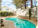 Backyard pool offers a serene setting with beautiful landscaping, providing a private oasis for relaxation and recreation at 9552 Wooden Pier Way, Las Vegas, NV 89117
