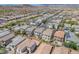 Expansive aerial view of a residential community showcasing numerous homes and mountain views in the distance at 9872 Chief Sky St, Las Vegas, NV 89178