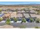 An aerial view showcases the community and surrounding landscape with mountains in the distance at 9872 Chief Sky St, Las Vegas, NV 89178