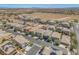An aerial view showcasing the community and the surrounding landscape with mountains in the distance at 9872 Chief Sky St, Las Vegas, NV 89178
