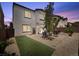 This backyard features low maintenance rock landscaping and an artificial turf area at 9872 Chief Sky St, Las Vegas, NV 89178