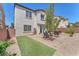 Well maintained backyard with artificial turf, desert landscaping, and patio at 9872 Chief Sky St, Las Vegas, NV 89178