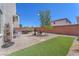 Wide view of backyard with desert landscaping, patio, and artificial turf at 9872 Chief Sky St, Las Vegas, NV 89178