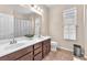Bathroom featuring double sinks, vanity, mirror, and separate shower at 9872 Chief Sky St, Las Vegas, NV 89178