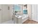 Bathroom showcases a soaking tub with a shower, neutral decor, and bright natural light at 9872 Chief Sky St, Las Vegas, NV 89178