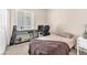 Neutral toned bedroom featuring bed, desk with fish tank and a desk chair at 9872 Chief Sky St, Las Vegas, NV 89178