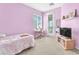 A charming bedroom offers a desk, shelves, and a door to the balcony at 9872 Chief Sky St, Las Vegas, NV 89178