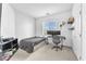 Neutral toned bedroom featuring a bed, desk, and shelving with decor at 9872 Chief Sky St, Las Vegas, NV 89178