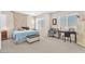 Comfortable bedroom featuring multiple windows, carpet flooring, and ample space for a desk at 9872 Chief Sky St, Las Vegas, NV 89178