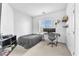Bright bedroom with a twin bed, desk, and neutral-toned carpet, offering a cozy and functional space at 9872 Chief Sky St, Las Vegas, NV 89178