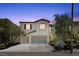 Two-story home featuring a spacious two car garage, neutral paint, and tasteful landscaping at 9872 Chief Sky St, Las Vegas, NV 89178