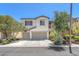Two-story home featuring a spacious two car garage, neutral paint, and tasteful landscaping at 9872 Chief Sky St, Las Vegas, NV 89178