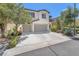 Two-story home featuring a spacious two car garage, neutral paint, and tasteful landscaping at 9872 Chief Sky St, Las Vegas, NV 89178
