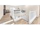 Bright hallway featuring white railings and wood-look flooring connecting different levels of the home at 9872 Chief Sky St, Las Vegas, NV 89178