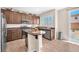 Beautiful eat-in kitchen with stainless steel appliances, tile floors, and backyard views at 9872 Chief Sky St, Las Vegas, NV 89178