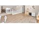 Spacious living area with wood flooring, natural light, and loft access at 9872 Chief Sky St, Las Vegas, NV 89178