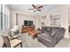 Comfortable living room features a ceiling fan, a leather couch and stylish furnishings at 9872 Chief Sky St, Las Vegas, NV 89178