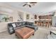 Open-concept living room featuring a leather sectional sofa and seamless flow into the dining area at 9872 Chief Sky St, Las Vegas, NV 89178