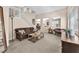 Comfortable living room features neutral tones, plush seating, and staircase access at 9872 Chief Sky St, Las Vegas, NV 89178