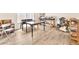 Unfurnished living space showing wood-look flooring and a variety of tables, chairs and shelving at 9872 Chief Sky St, Las Vegas, NV 89178