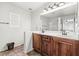 Bathroom featuring a double sink with a large mirror and tiled flooring at 9962 Derby Creek Way, Las Vegas, NV 89148
