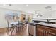 Kitchen and dining area with stainless steel appliances, laminate floors and ample natural light at 9962 Derby Creek Way, Las Vegas, NV 89148